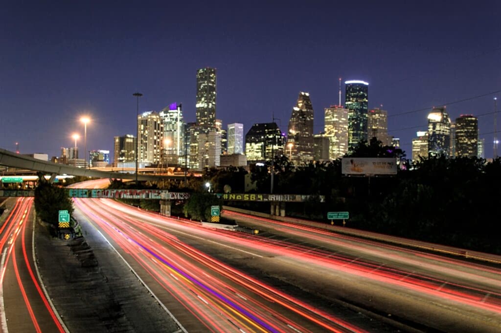 A night view of traffic in Houston TX, where affordable cleaning services are sought after.