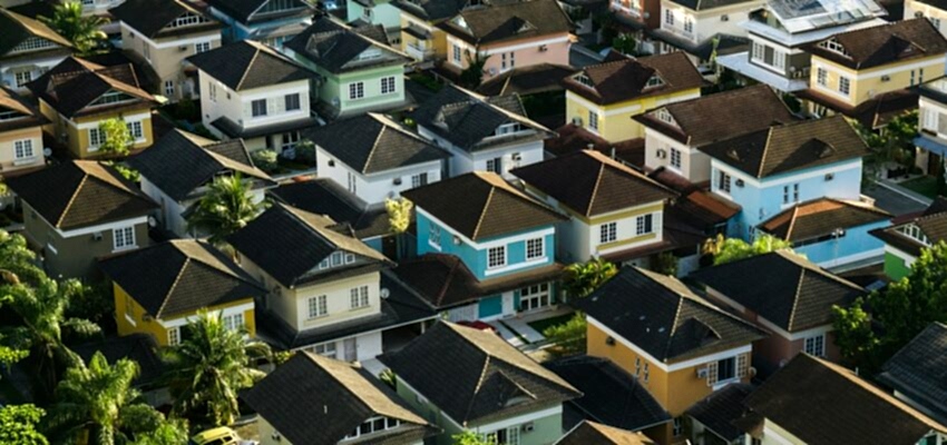 An aerial view of suburban homes that require affordable cleaning services.