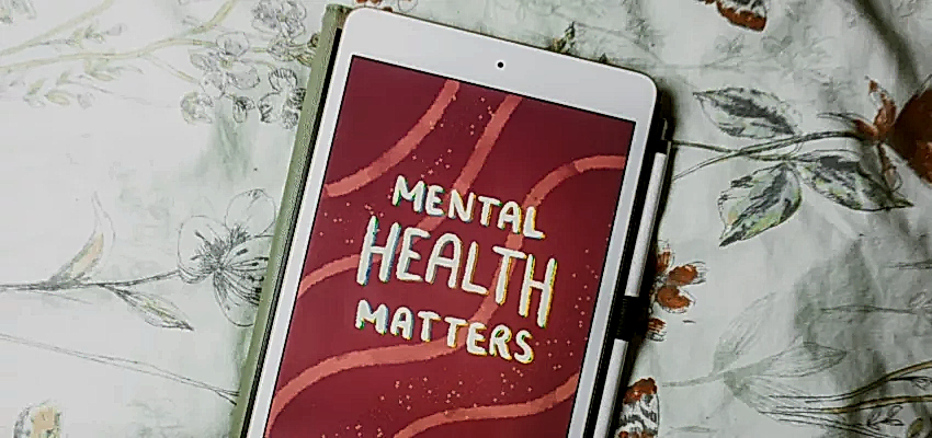 An ipad on a floral bedspread that has a lettering illustration on it, reading 'mental health matters'. ADHD cleaning tips provide support for people living with ADHD.