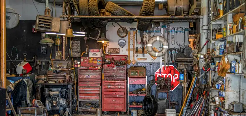 A messy garage from someone who needs garage cleaning tips for the overwhelmed.