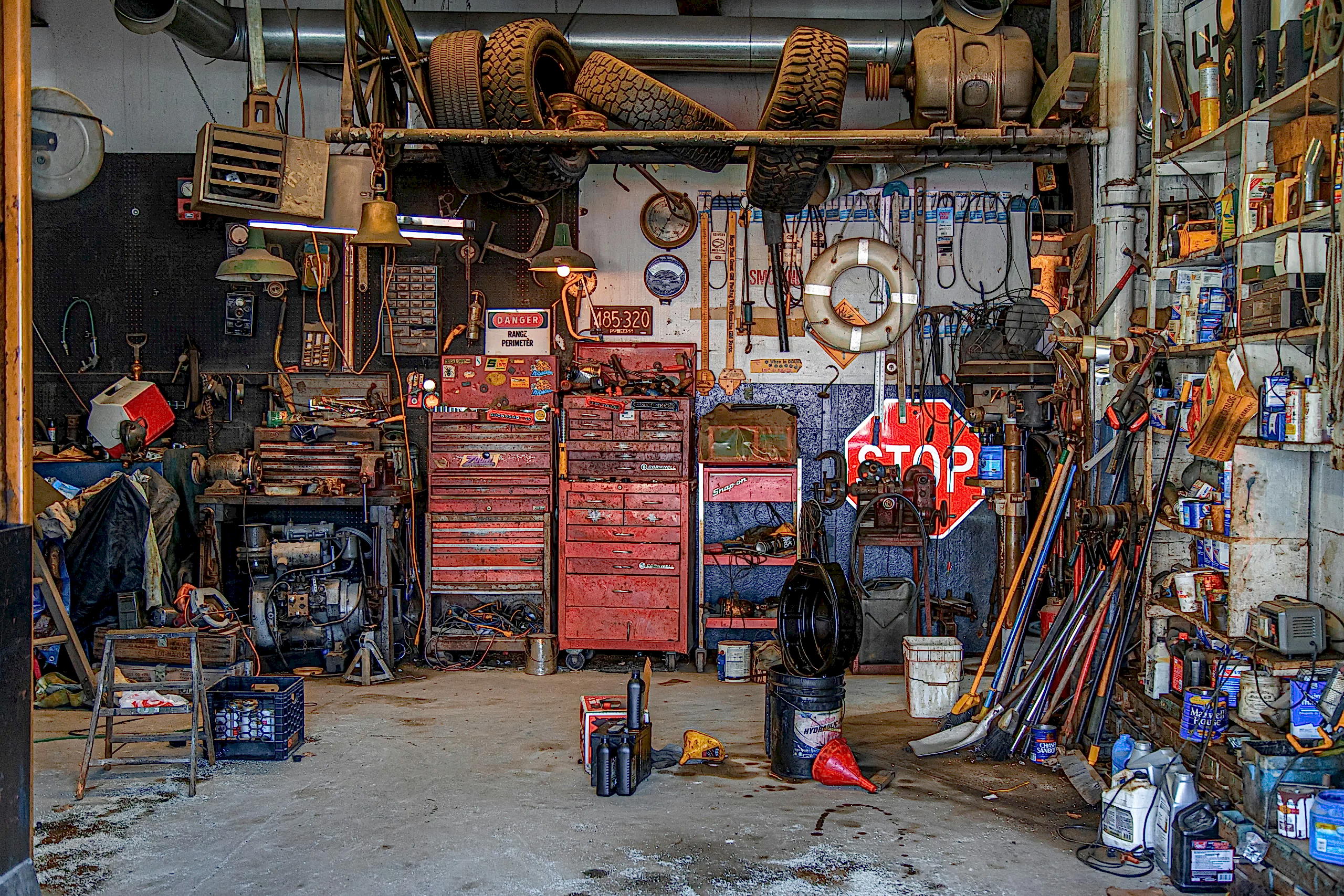 A messy garage from someone who needs garage cleaning tips for the overwhelmed.