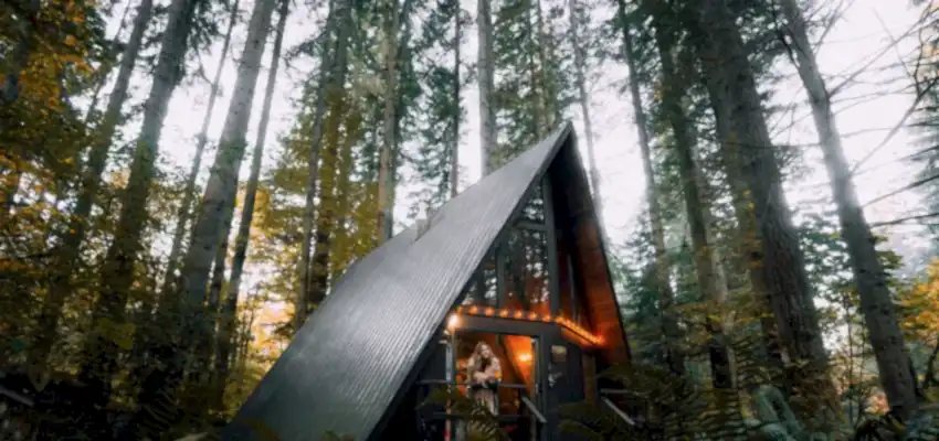 An a-frame cabin in the woods is an Airbnb. Those staying wonder how much do you tip airbnb cleaner?