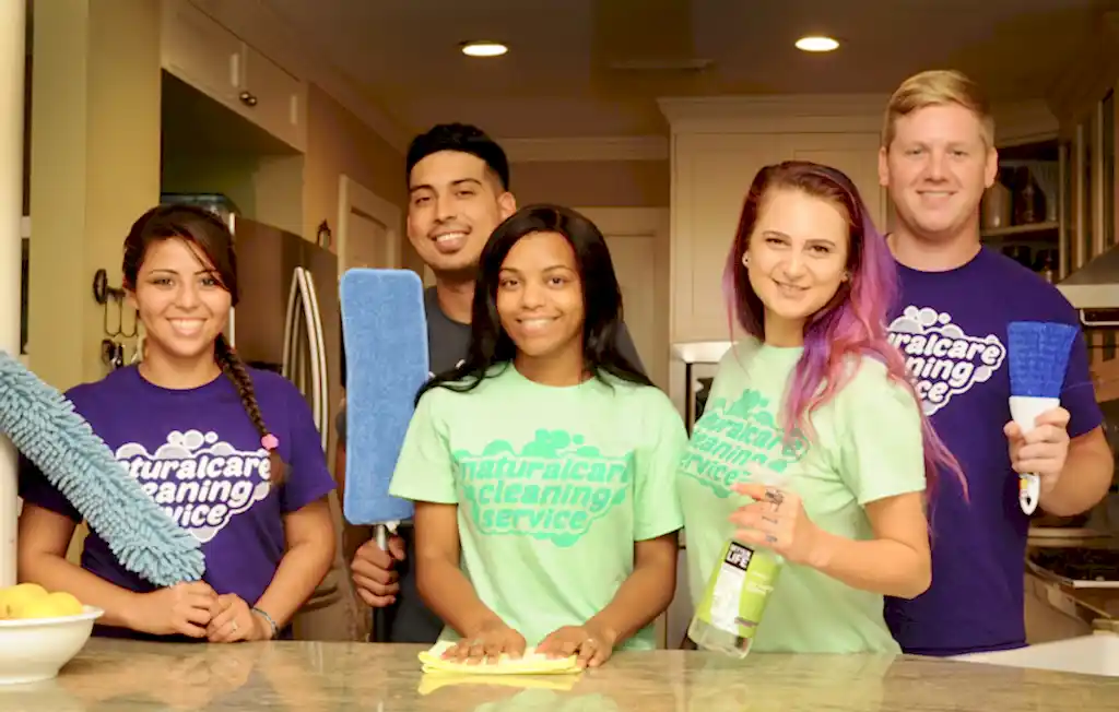 A group of maids from Naturalcare Cleaning services are posing for a group photo in Humble TX.